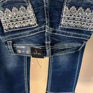 New girls' jeans by Grace with sparkly pocket. Two pair of jeans at size 5.